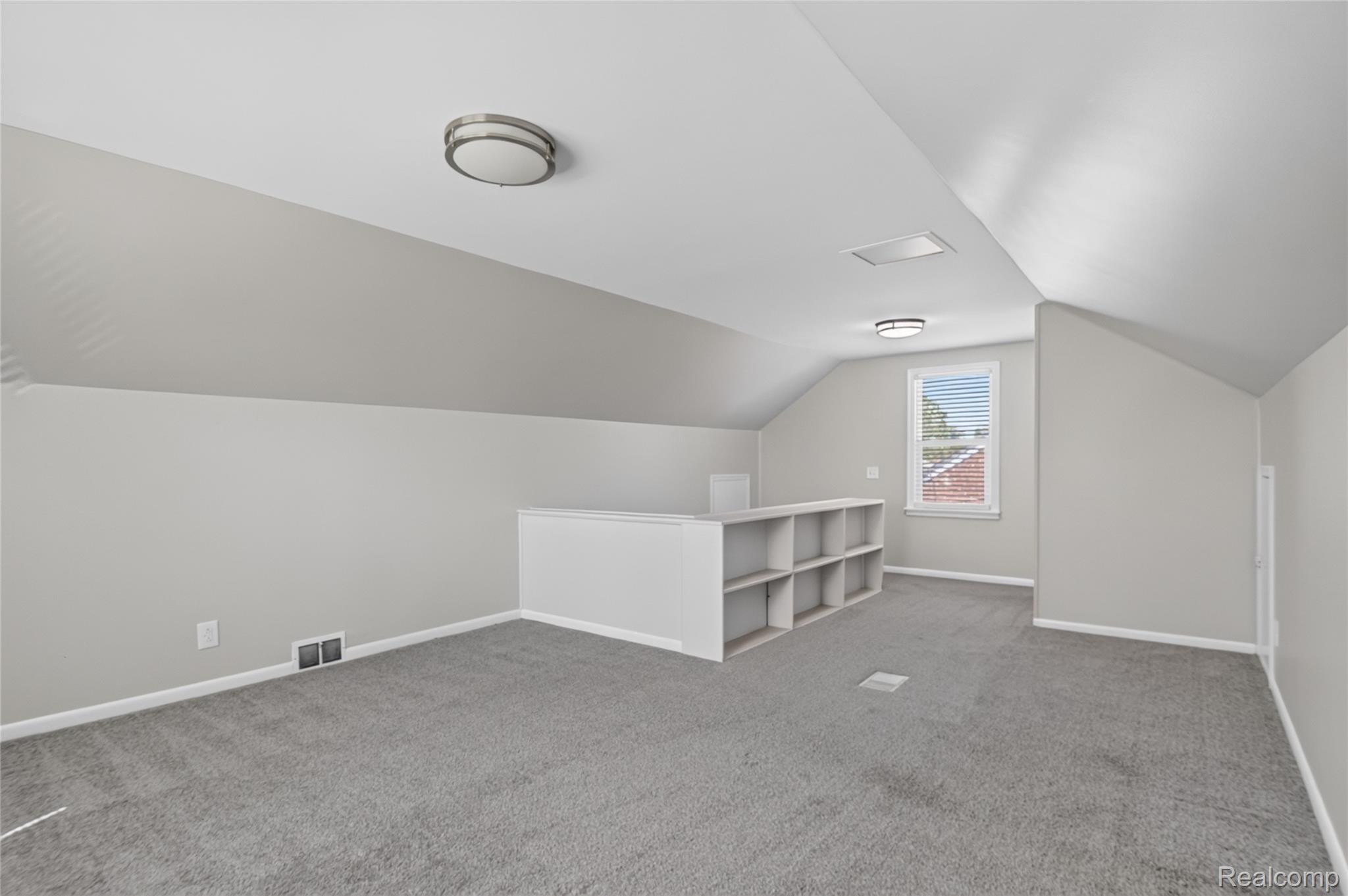 12972 Callender Street Southgate, MI 48195 - Photo 29 of 40 Carpeted bonus room featuring sloped ceilings, a built-in shelving unit, and a window with blinds