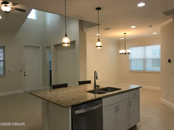 a kitchen with granite countertop a sink and a stove