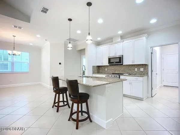 a bathroom with a granite countertop sink two mirror and a shower