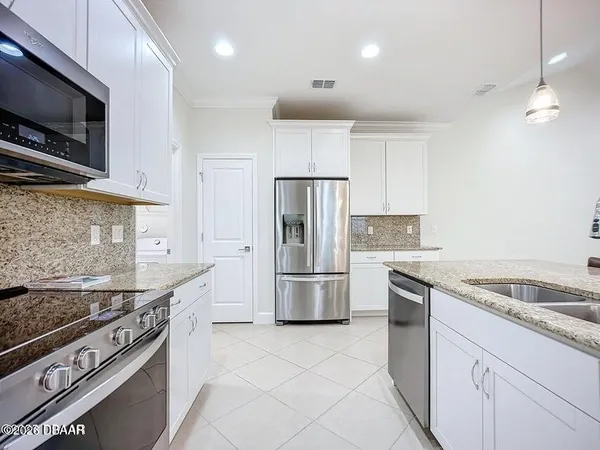 a bathroom with a granite countertop sink a toilet a mirror a bathtub and shower