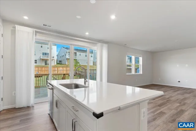 a kitchen with a refrigerator stove and white cabinets