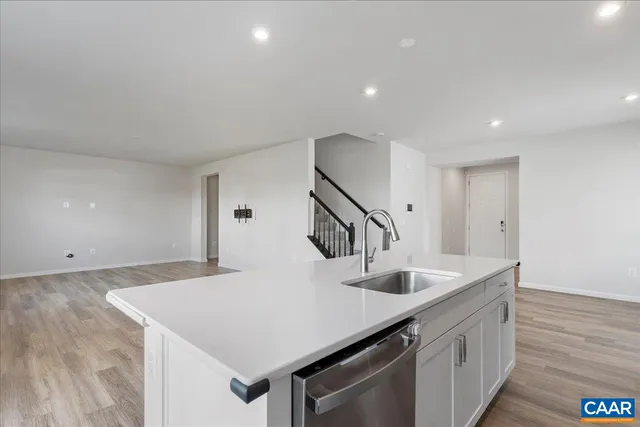 a kitchen with stainless steel appliances a refrigerator sink and cabinets