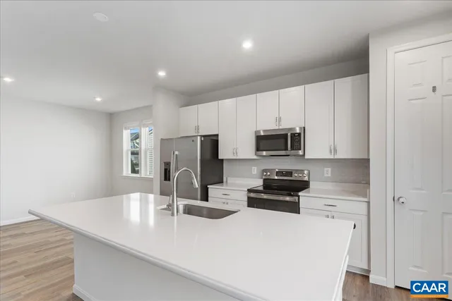 a kitchen with a refrigerator stove and microwave