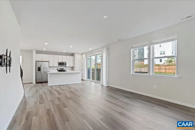 a view of entryway and gallery with wooden floor