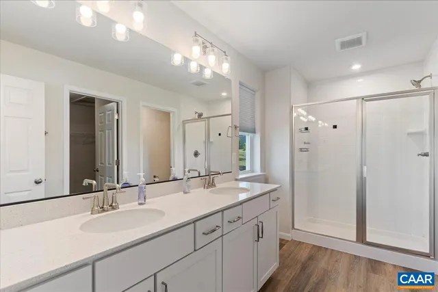a bathroom with a sink double vanity and a mirror