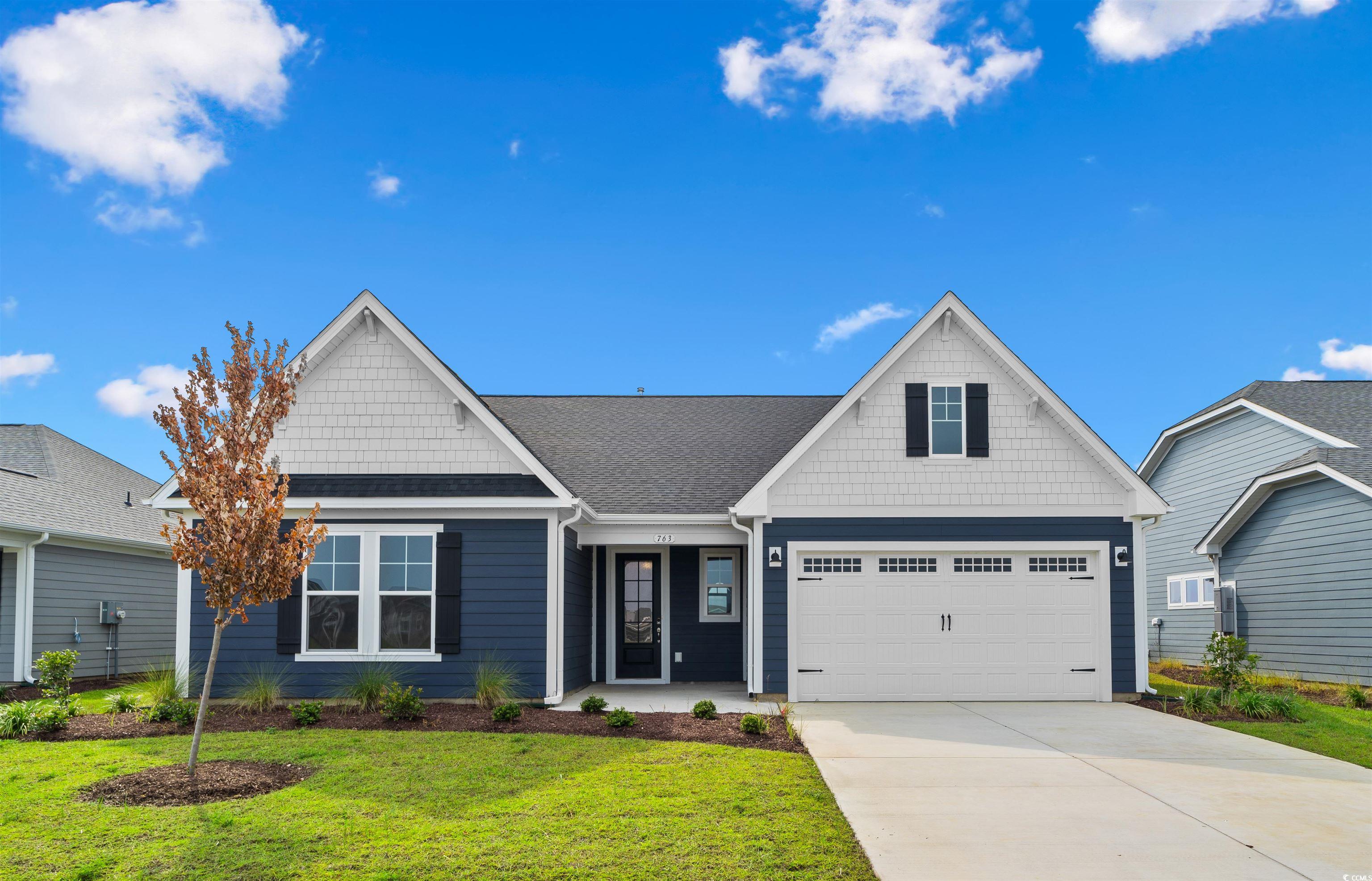 763 St Vincent Loop Little River, SC 29566 - Photo 1 of 33 View of front of home featuring a front lawn, concrete driveway, a garage, and a shingled roof