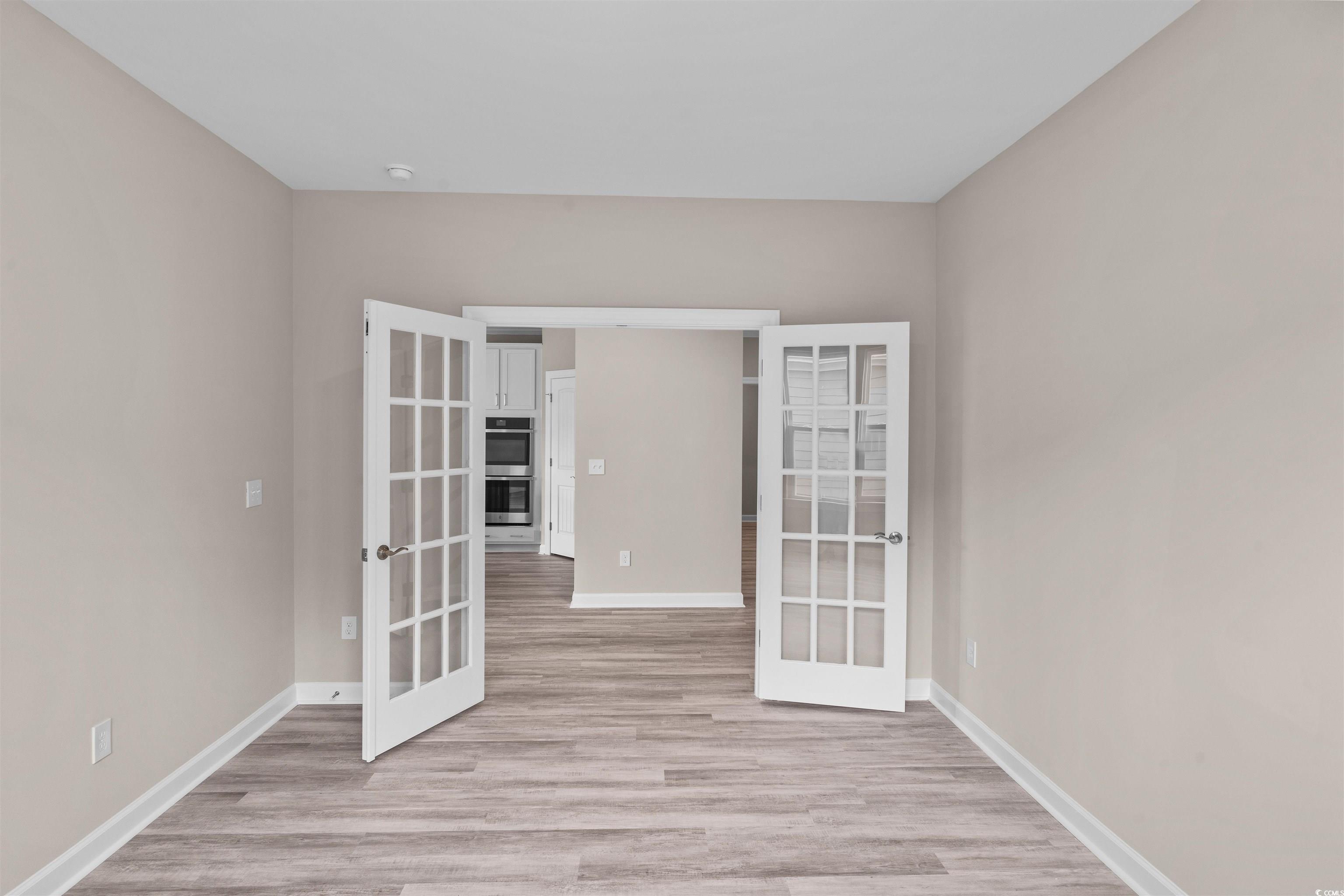763 St Vincent Loop Little River, SC 29566 - Photo 19 of 33 Unfurnished room featuring french doors and light wood-style floors