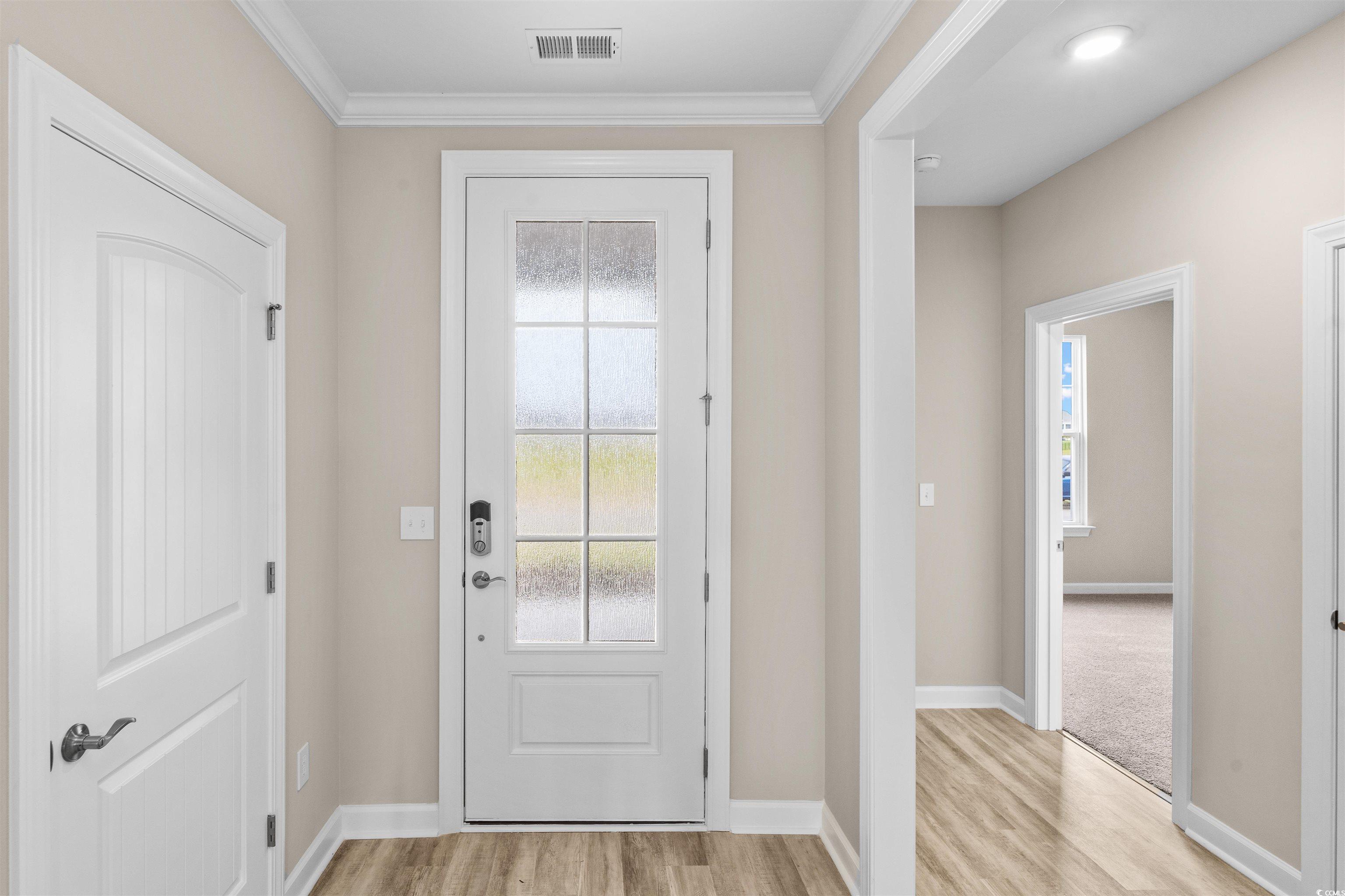 763 St Vincent Loop Little River, SC 29566 - Photo 25 of 33 Entryway with light wood-style floors and crown molding