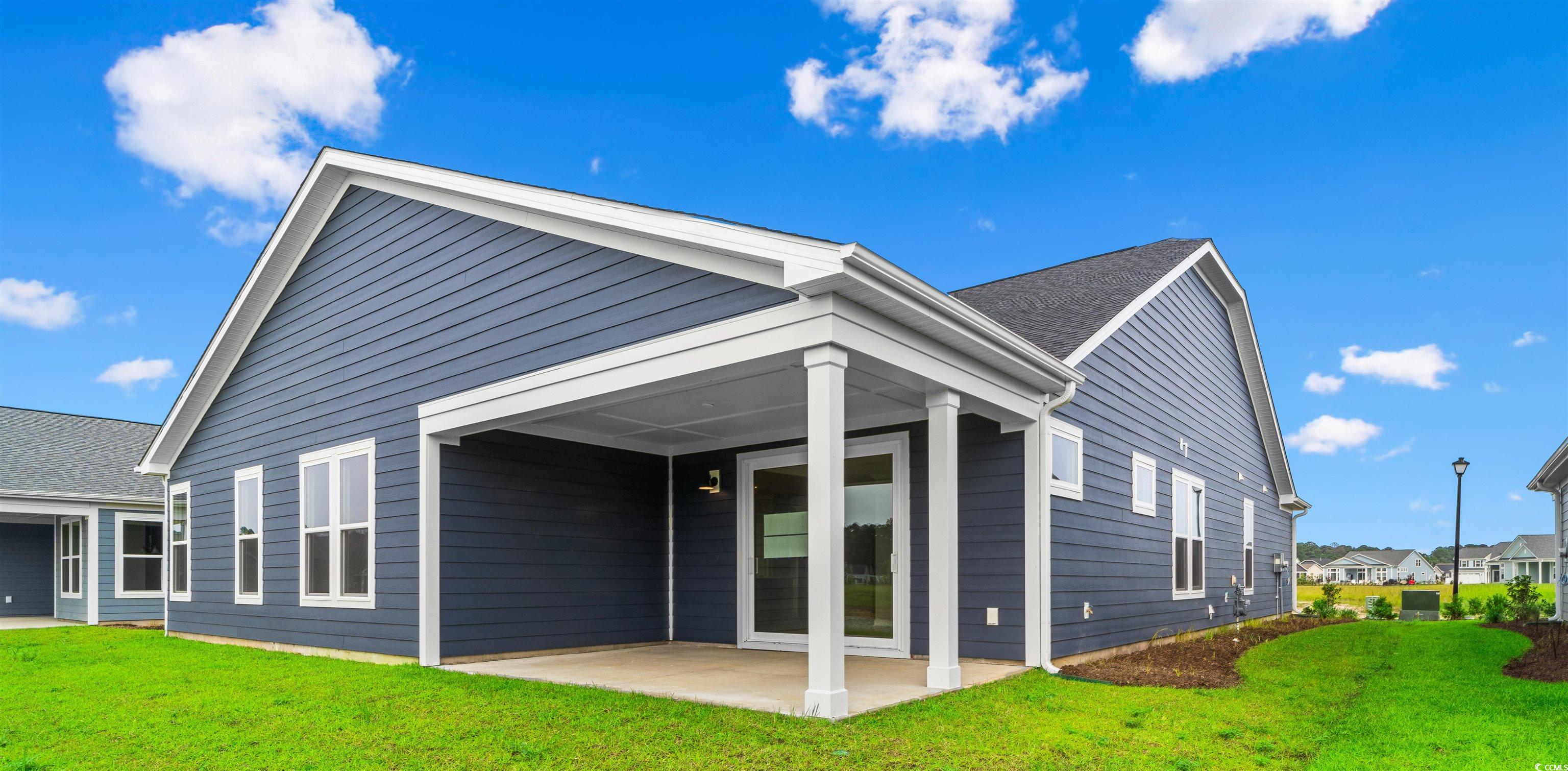 763 St Vincent Loop Little River, SC 29566 - Photo 4 of 33 Rear view of house featuring a yard and a patio