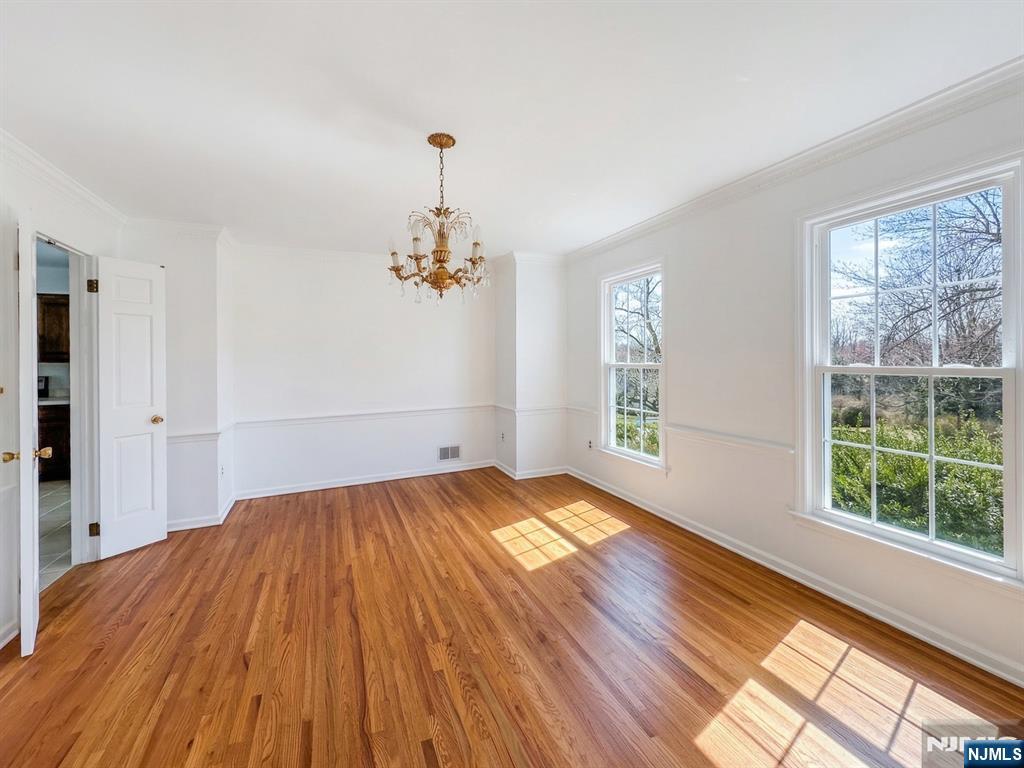 139 Berkeley Circle Bernards, NJ 07920 - Photo 11 of 36 a view of empty room with wooden floor and fan