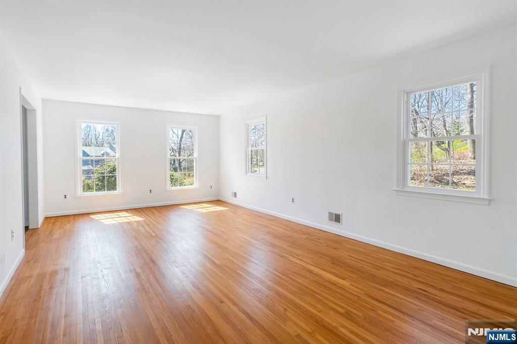 139 Berkeley Circle Bernards, NJ 07920 - Photo 17 of 36 an empty room with wooden floor and windows