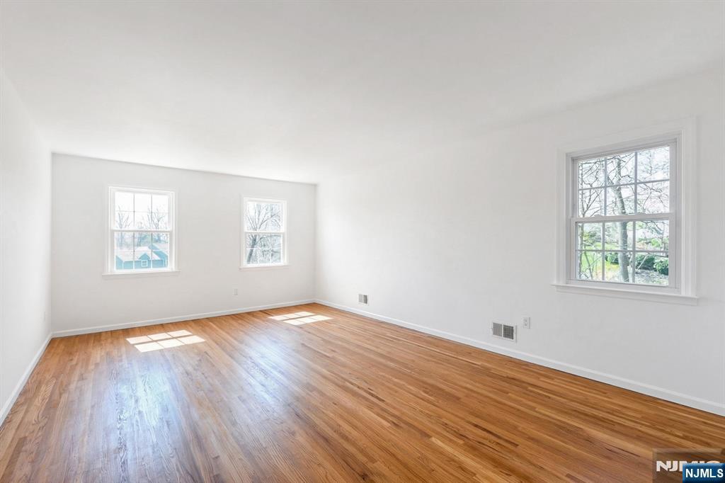 139 Berkeley Circle Bernards, NJ 07920 - Photo 19 of 36 an empty room with wooden floor and windows