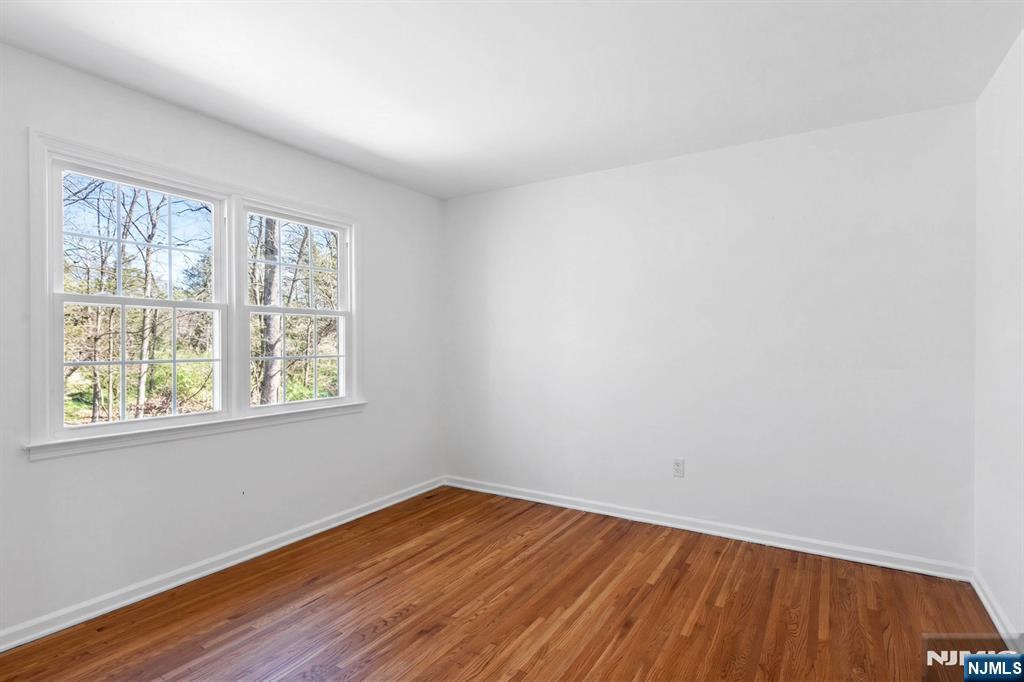 139 Berkeley Circle Bernards, NJ 07920 - Photo 24 of 36 an empty room with wooden floor and windows