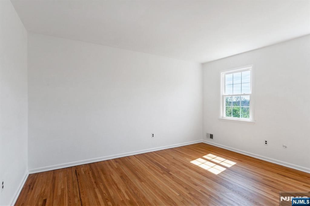 139 Berkeley Circle Bernards, NJ 07920 - Photo 28 of 36 a view of empty room with wooden floor and fan