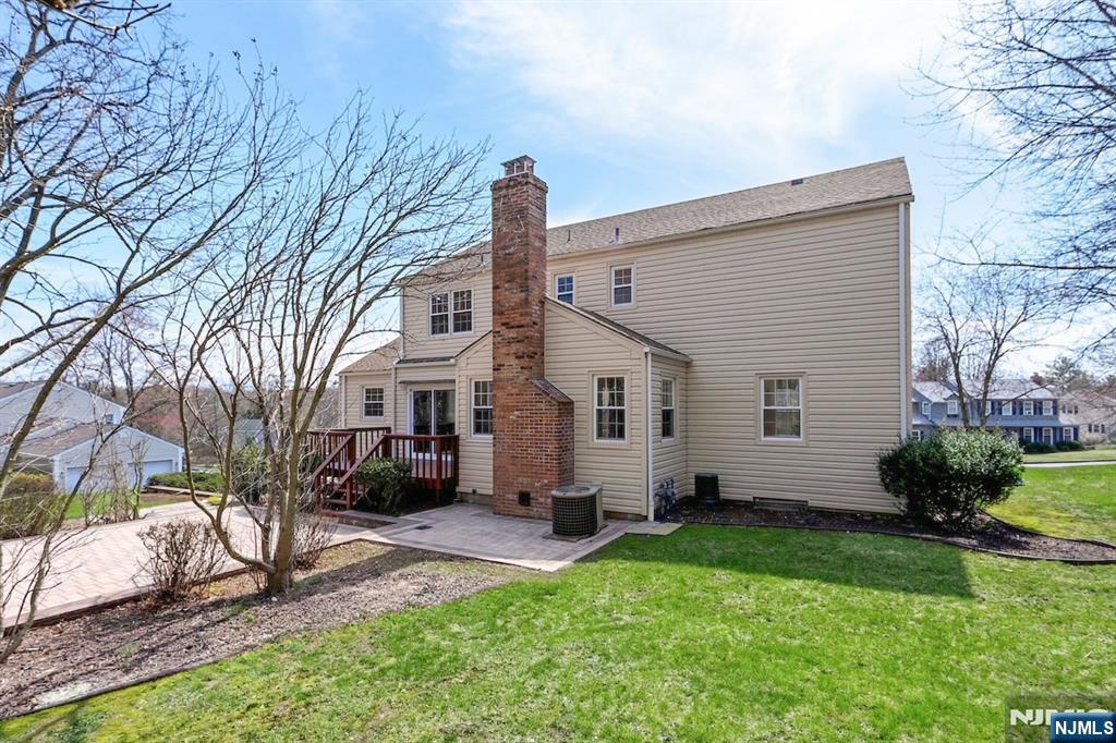 139 Berkeley Circle Bernards, NJ 07920 - Photo 29 of 36 a backyard of a house with potted plants and large tree