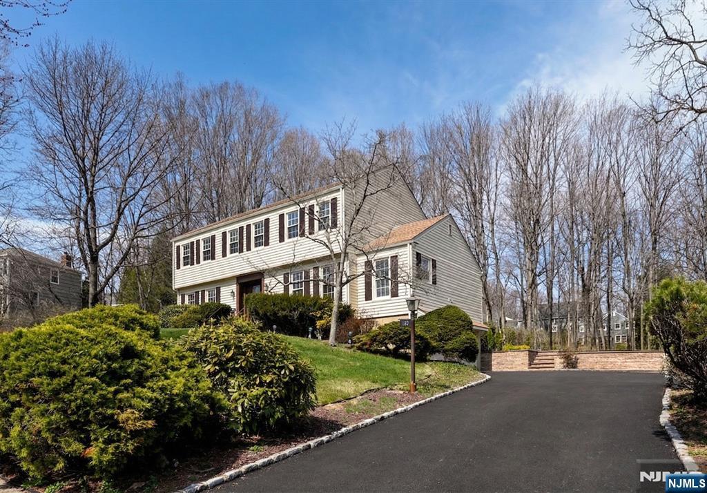 139 Berkeley Circle Bernards, NJ 07920 - Photo 32 of 36 a front view of a house with garden and trees