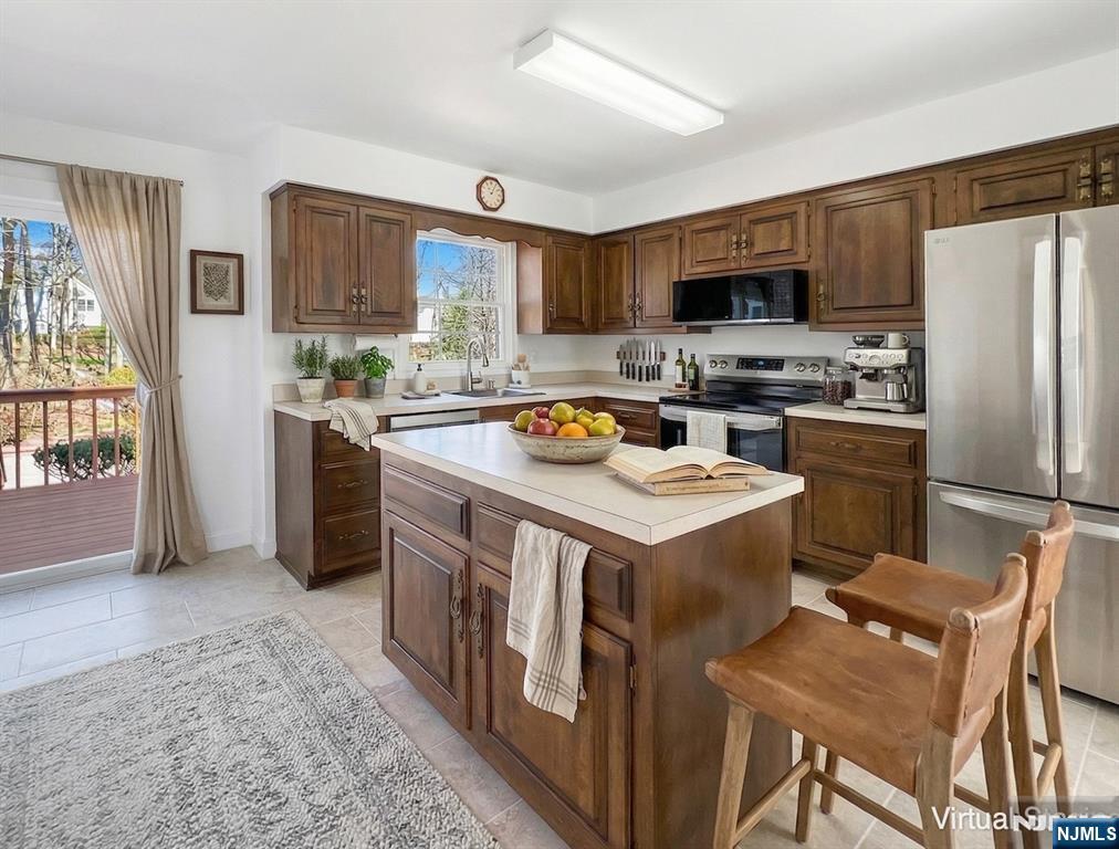 139 Berkeley Circle Bernards, NJ 07920 - Photo 9 of 36 a kitchen with a stove a sink and a refrigerator