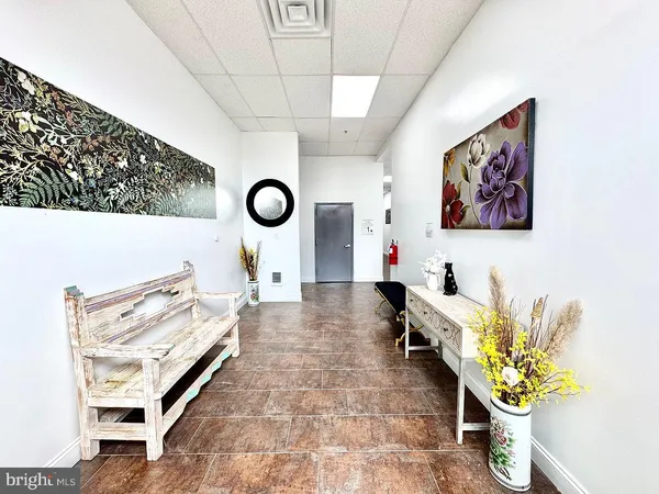 a living room with couches and painting on the wall