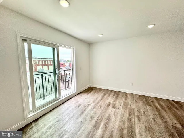 a view of an empty room and wooden floor