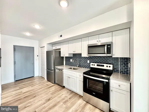a kitchen with a stove microwave and refrigerator