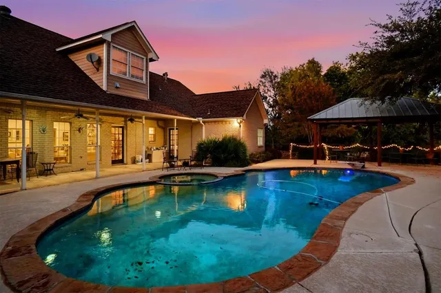 a swimming pool with outdoor seating and yard