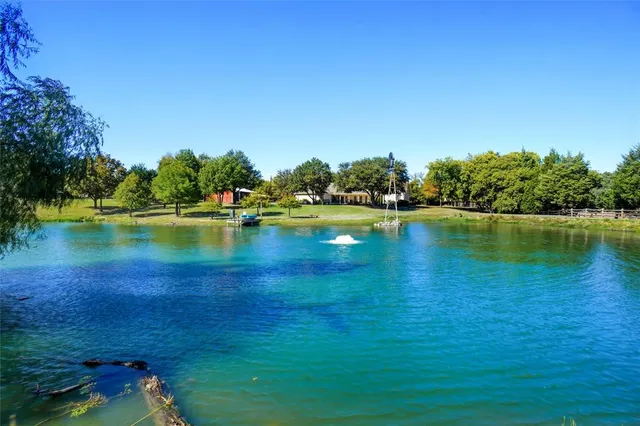 a view of a lake with houses in the background
