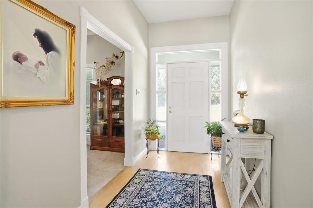 354 Jobson Road Sunnyvale, TX 75182 - Photo 17 of 39 a hallway with wooden floor and a chandelier