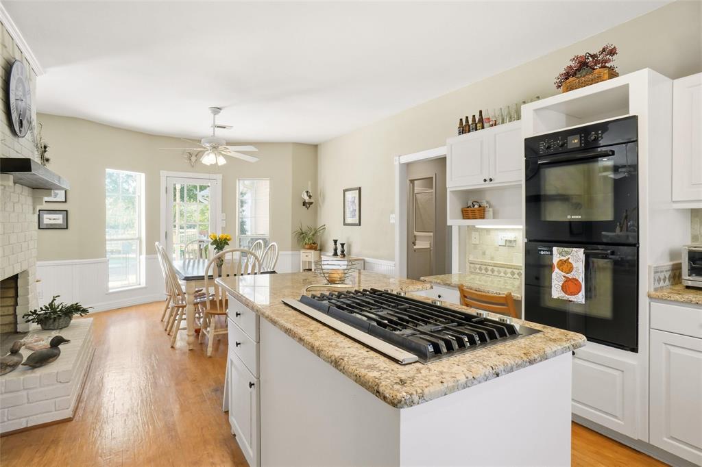 354 Jobson Road Sunnyvale, TX 75182 - Photo 24 of 39 a kitchen with a stove and wooden floor