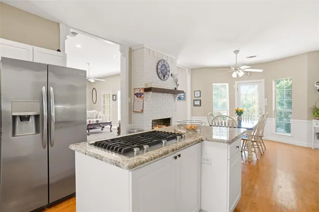 a kitchen that has a table chairs and a refrigerator