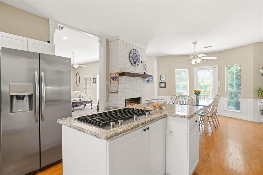 354 Jobson Road Sunnyvale, TX 75182 - Photo 25 of 39 a kitchen that has a table chairs and a refrigerator