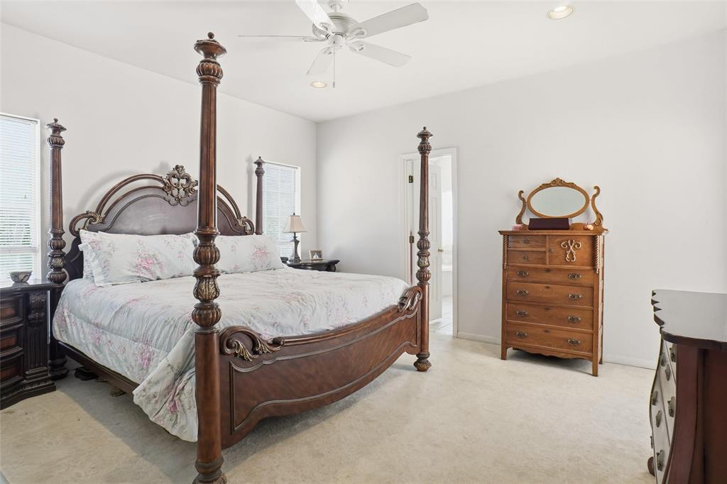 354 Jobson Road Sunnyvale, TX 75182 - Photo 26 of 39 a bedroom with a bed a dresser and with potted plants