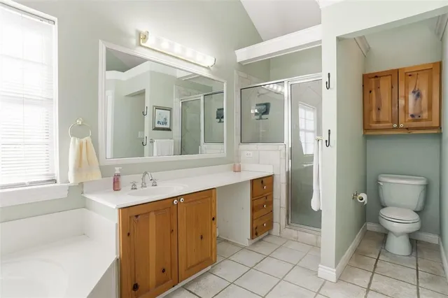 a spacious bathroom with a shower sink and toilet