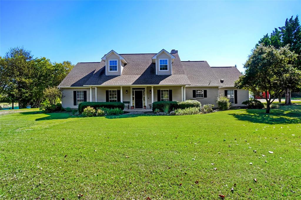 354 Jobson Road Sunnyvale, TX 75182 - Photo 3 of 39 a front view of a house with a yard table and chairs