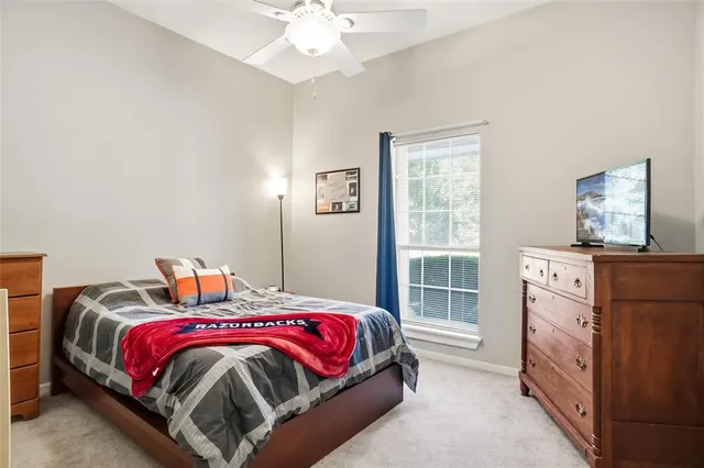 a bedroom with bed and a window