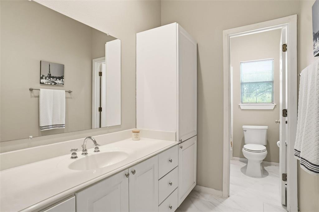 354 Jobson Road Sunnyvale, TX 75182 - Photo 33 of 39 a bathroom with a toilet sink and mirror