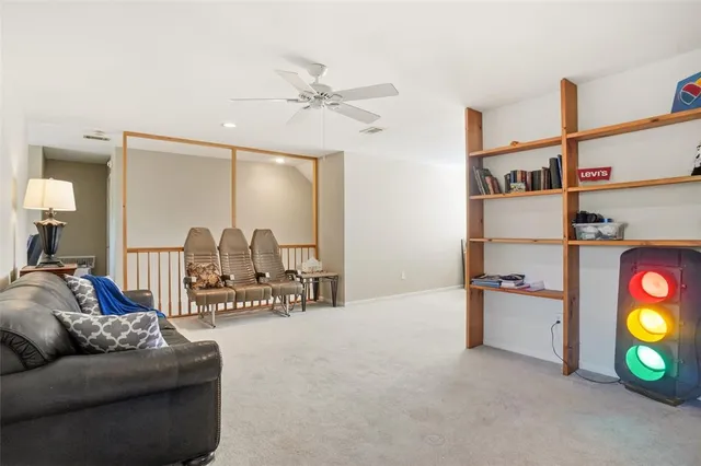 a living room with furniture and a floor to ceiling window