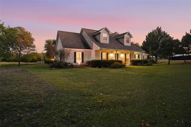 a front view of house with yard and trees