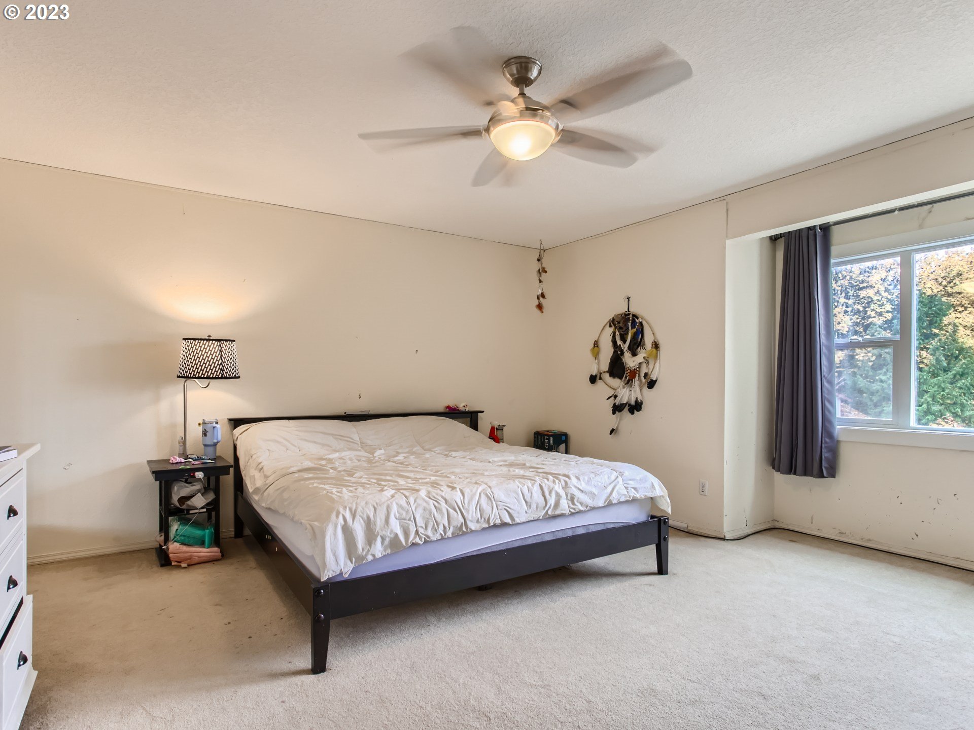 3120 Southwest Orchard Place Gresham, OR 97080 - Photo 13 of 27 a spacious bedroom with a bed and a chandelier
