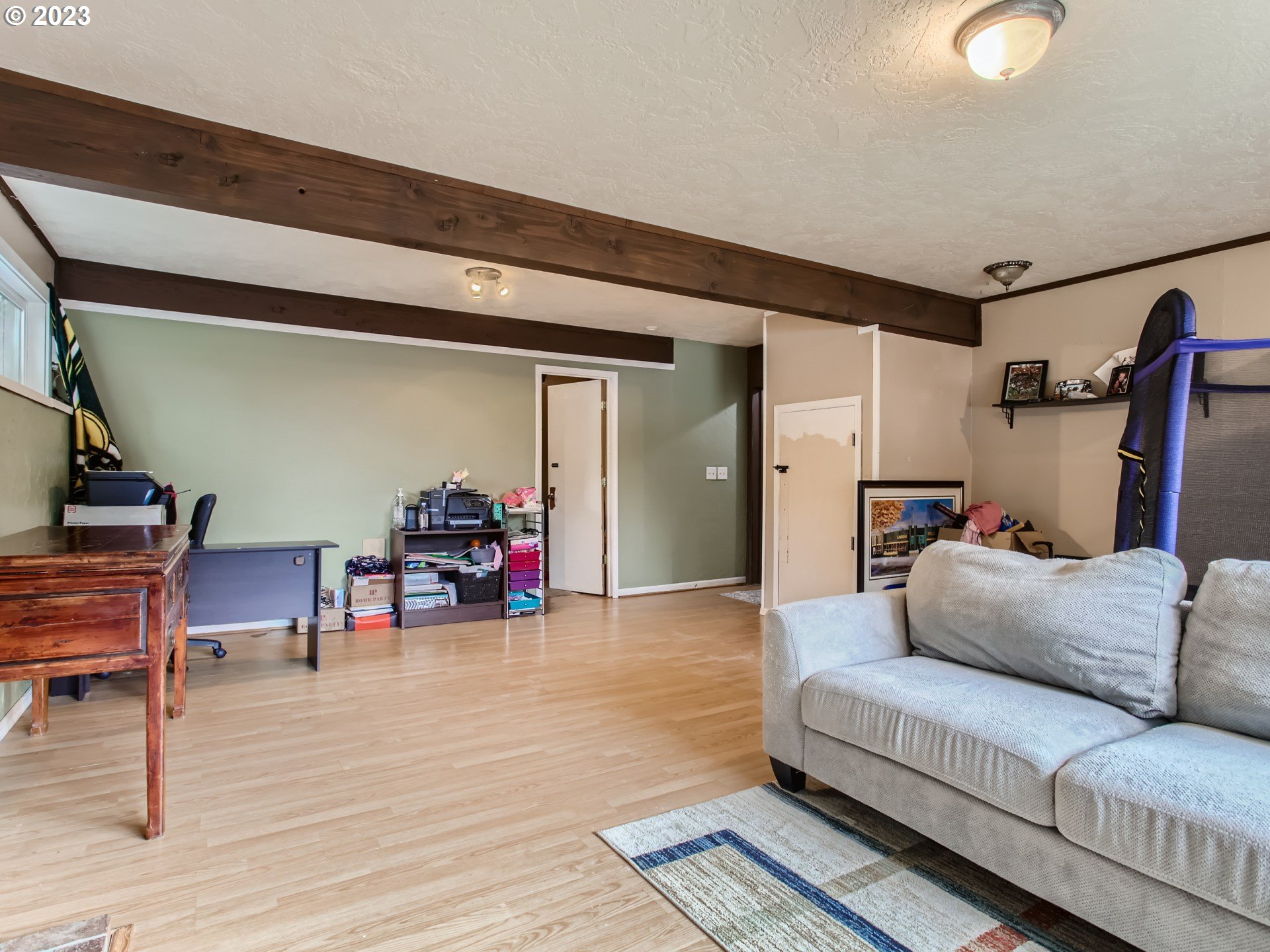 3120 Southwest Orchard Place Gresham, OR 97080 - Photo 20 of 27 a living room with furniture and a wooden floor
