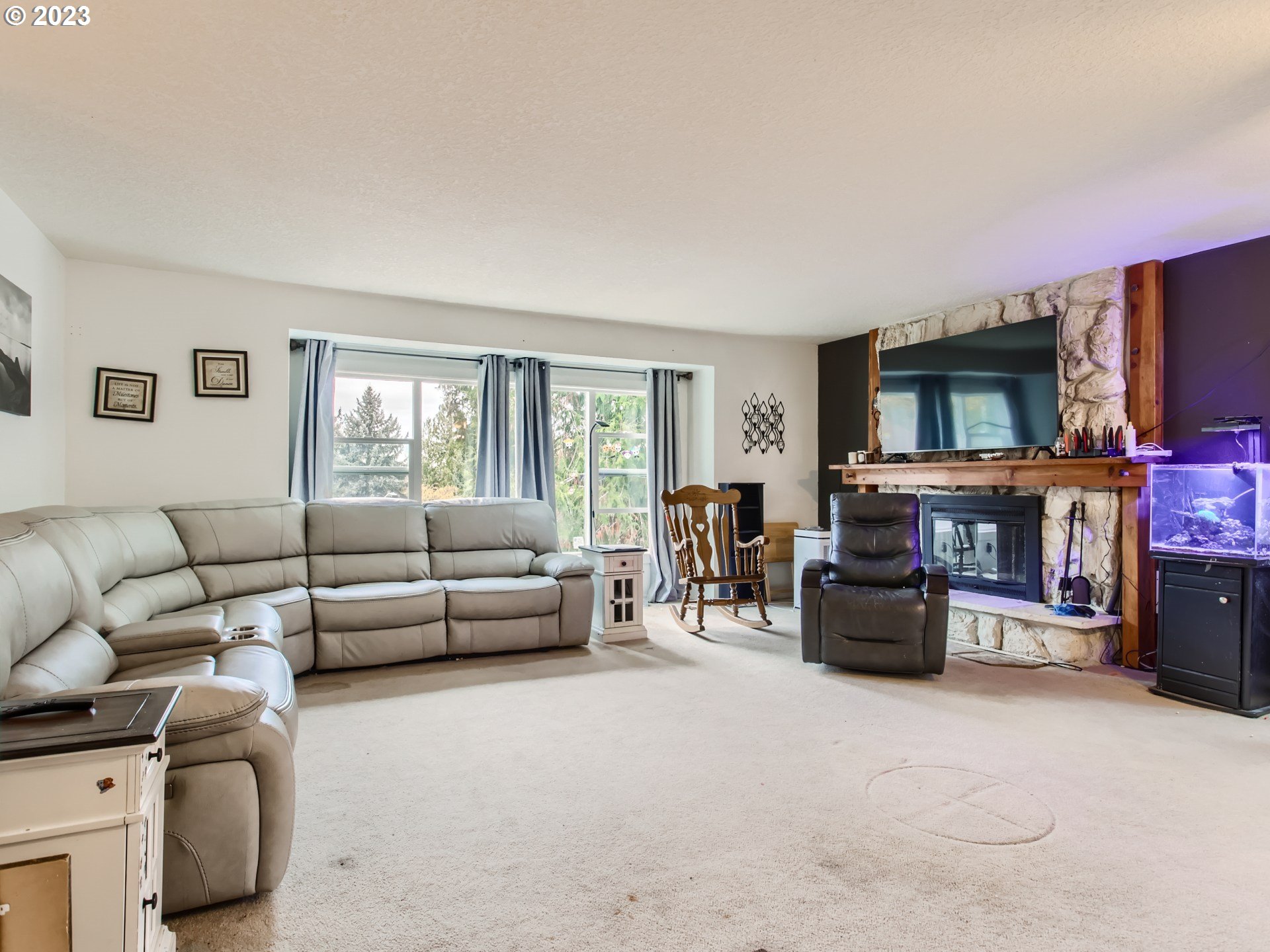 3120 Southwest Orchard Place Gresham, OR 97080 - Photo 6 of 27 a living room with furniture and a flat screen tv