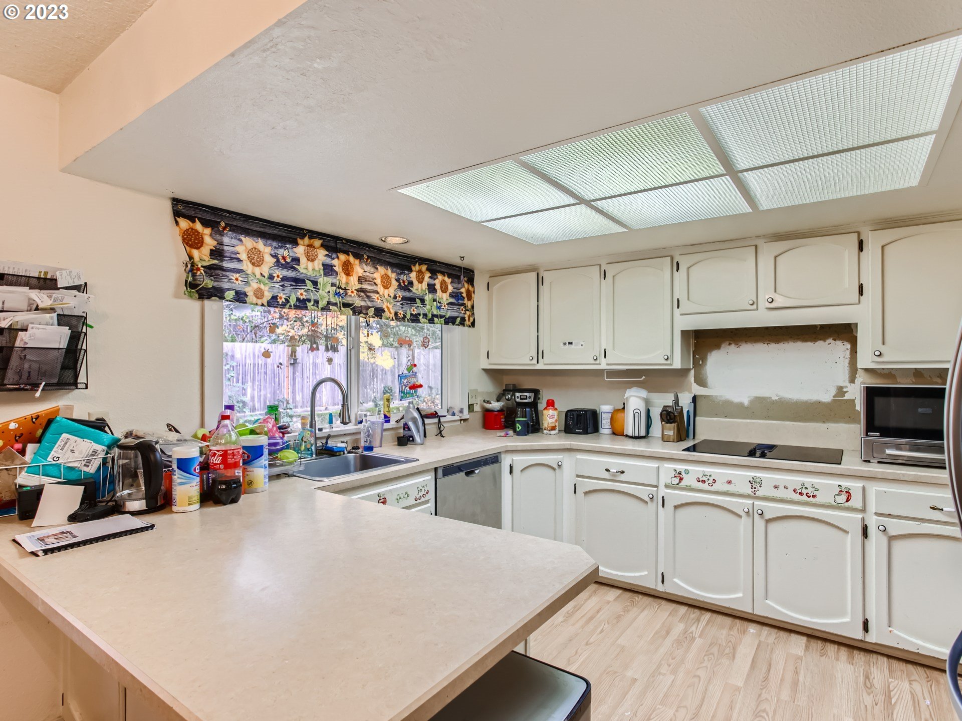 3120 Southwest Orchard Place Gresham, OR 97080 - Photo 8 of 27 a kitchen with a sink a stove and cabinets