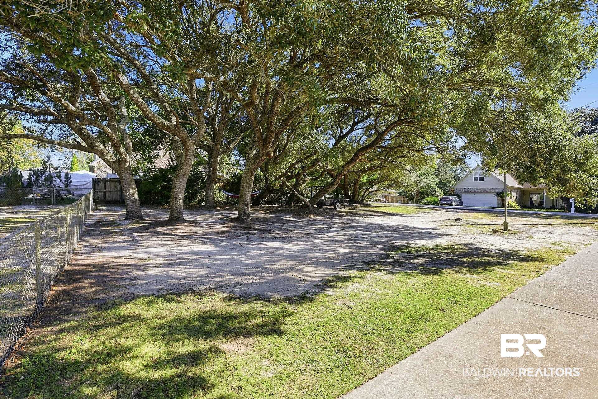25793 Bonito Avenue Orange Beach, AL 36561 - Photo 4 of 27 The extra lot beside this house is full of wonderful live oaks!