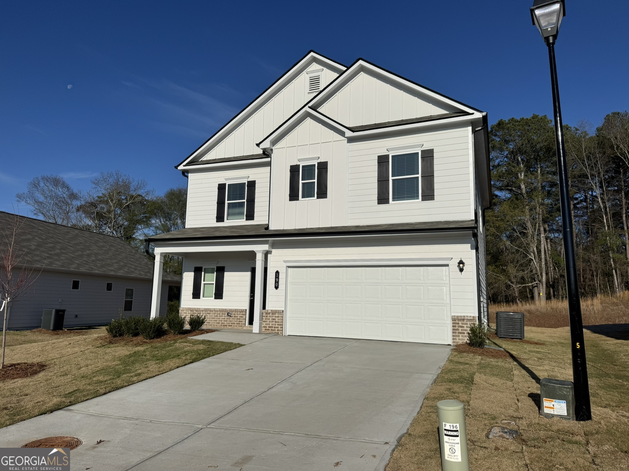 190 Fair Oak Lane Calhoun, GA 30701 - Photo 2 of 30 a view of a white house with wooden fence next to a road