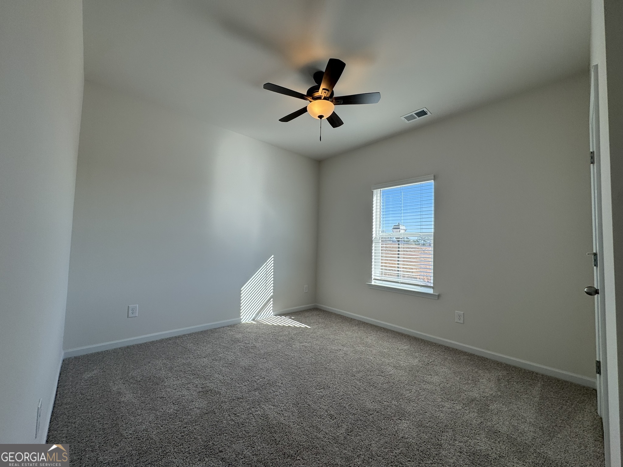 190 Fair Oak Lane Calhoun, GA 30701 - Photo 21 of 30 an empty room with a window and a fan