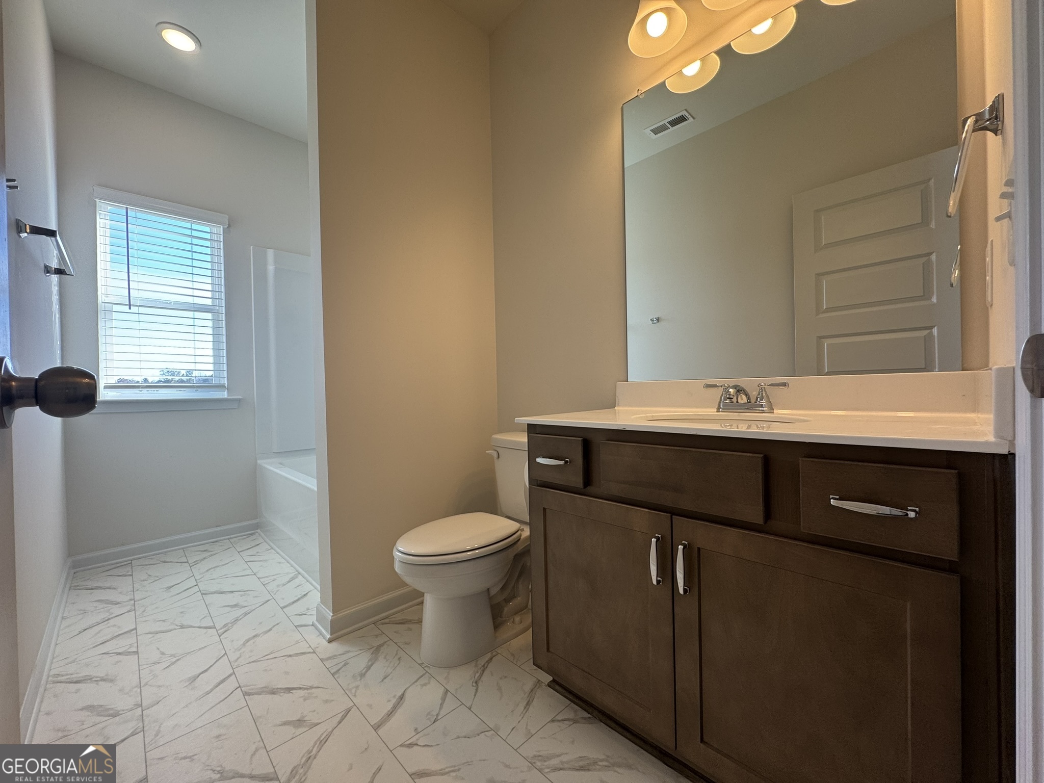 190 Fair Oak Lane Calhoun, GA 30701 - Photo 23 of 30 a bathroom with a sink vanity and a toilet