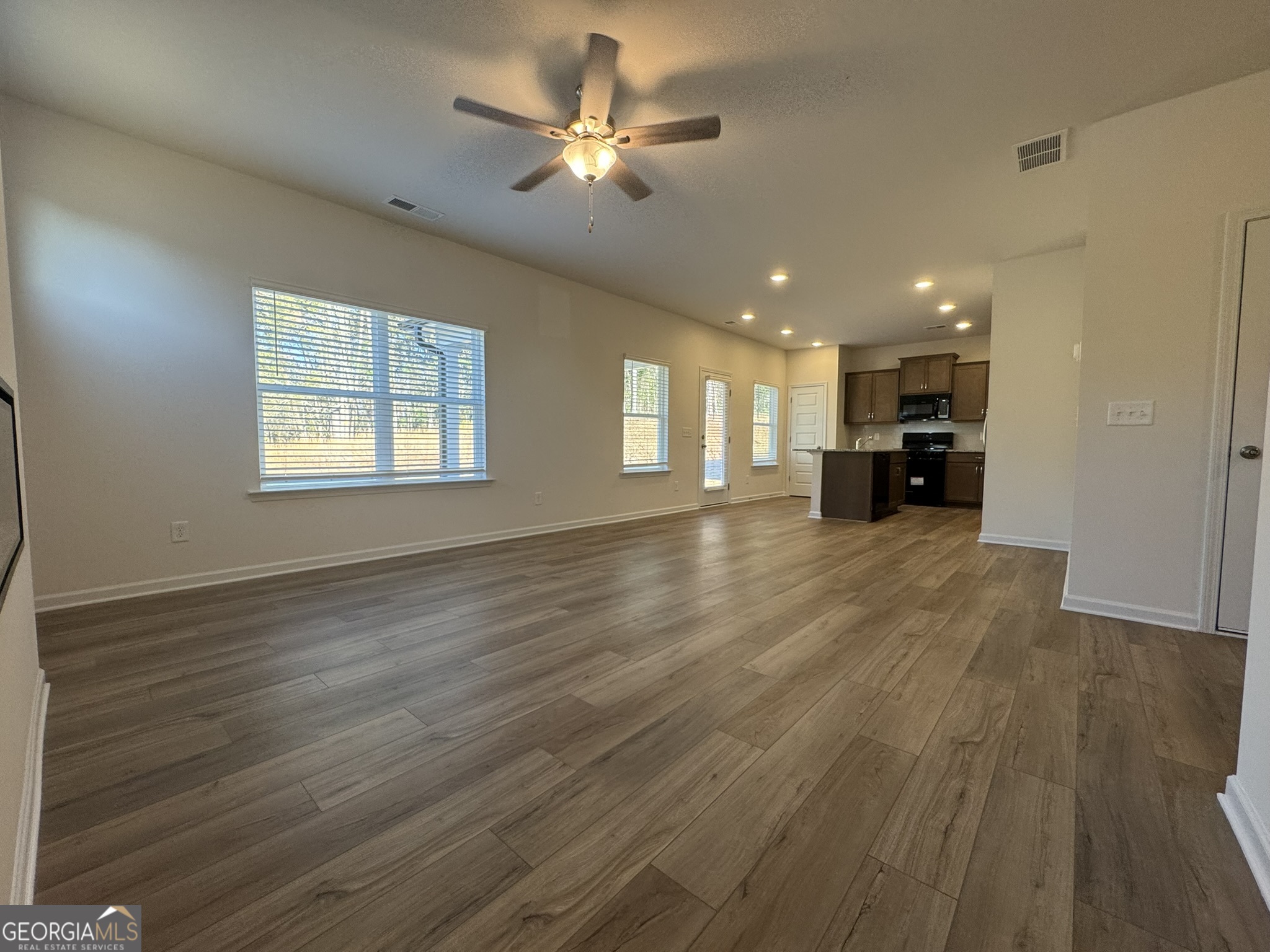 190 Fair Oak Lane Calhoun, GA 30701 - Photo 7 of 30 a view of an empty room with window and wooden floor