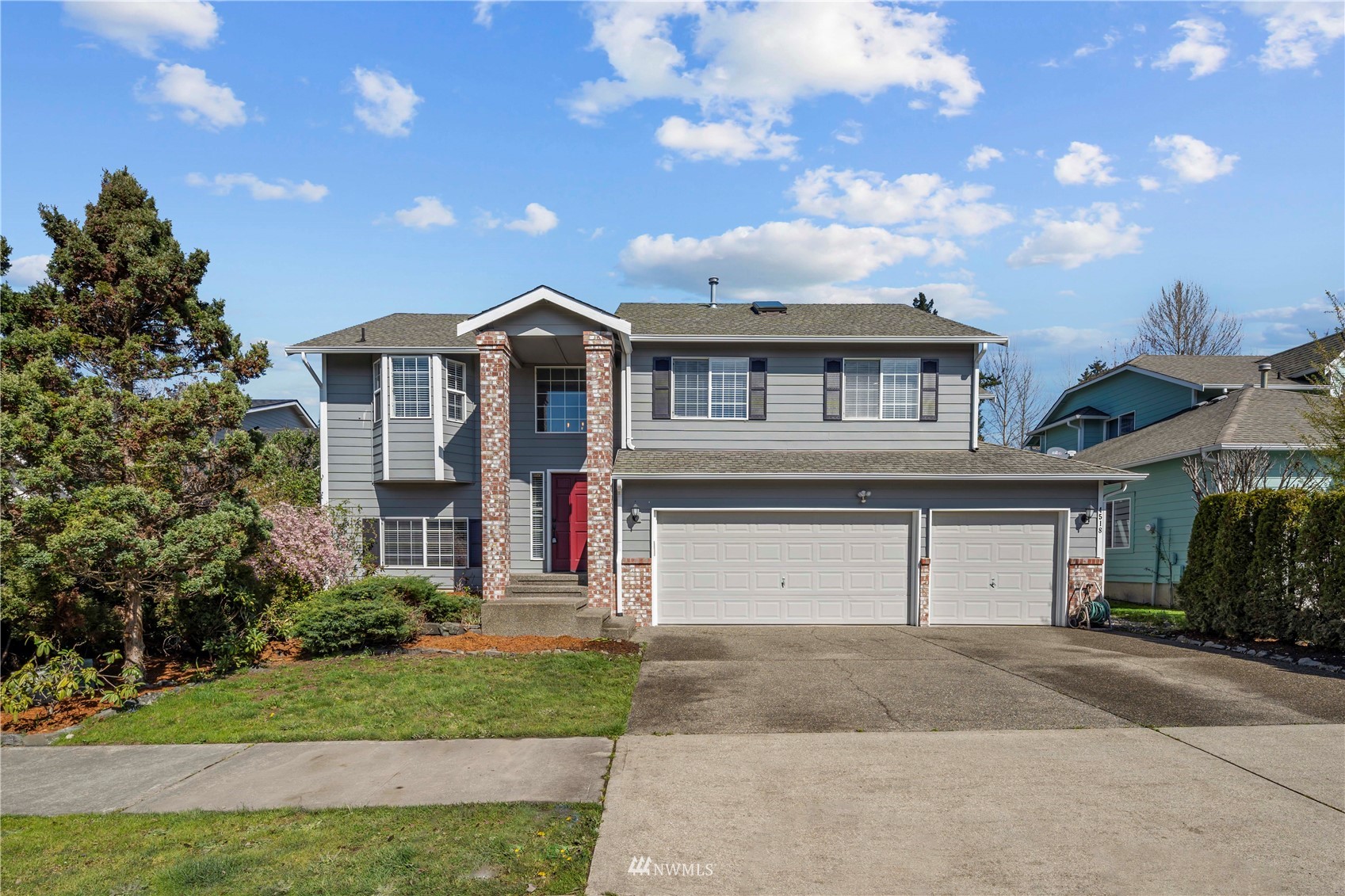 a front view of a house with a garden and garage