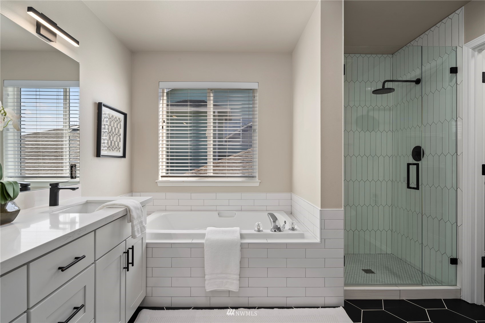 4518 Northeast 7th Place Renton, WA 98059 - Photo 11 of 24 a bathroom with a granite countertop sink a mirror a glass door and shower