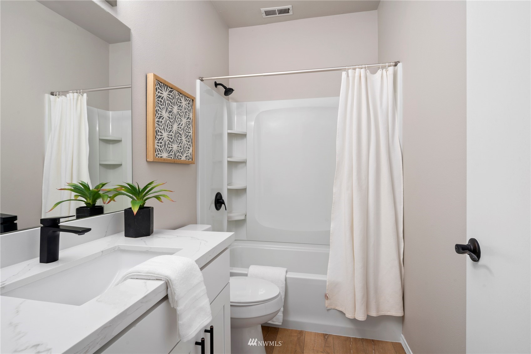 4518 Northeast 7th Place Renton, WA 98059 - Photo 19 of 24 a bathroom with a sink a toilet and shower curtain