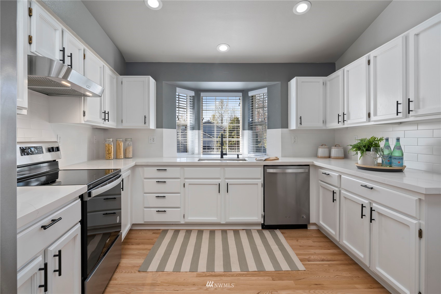 4518 Northeast 7th Place Renton, WA 98059 - Photo 6 of 24 a kitchen with cabinets appliances and a window